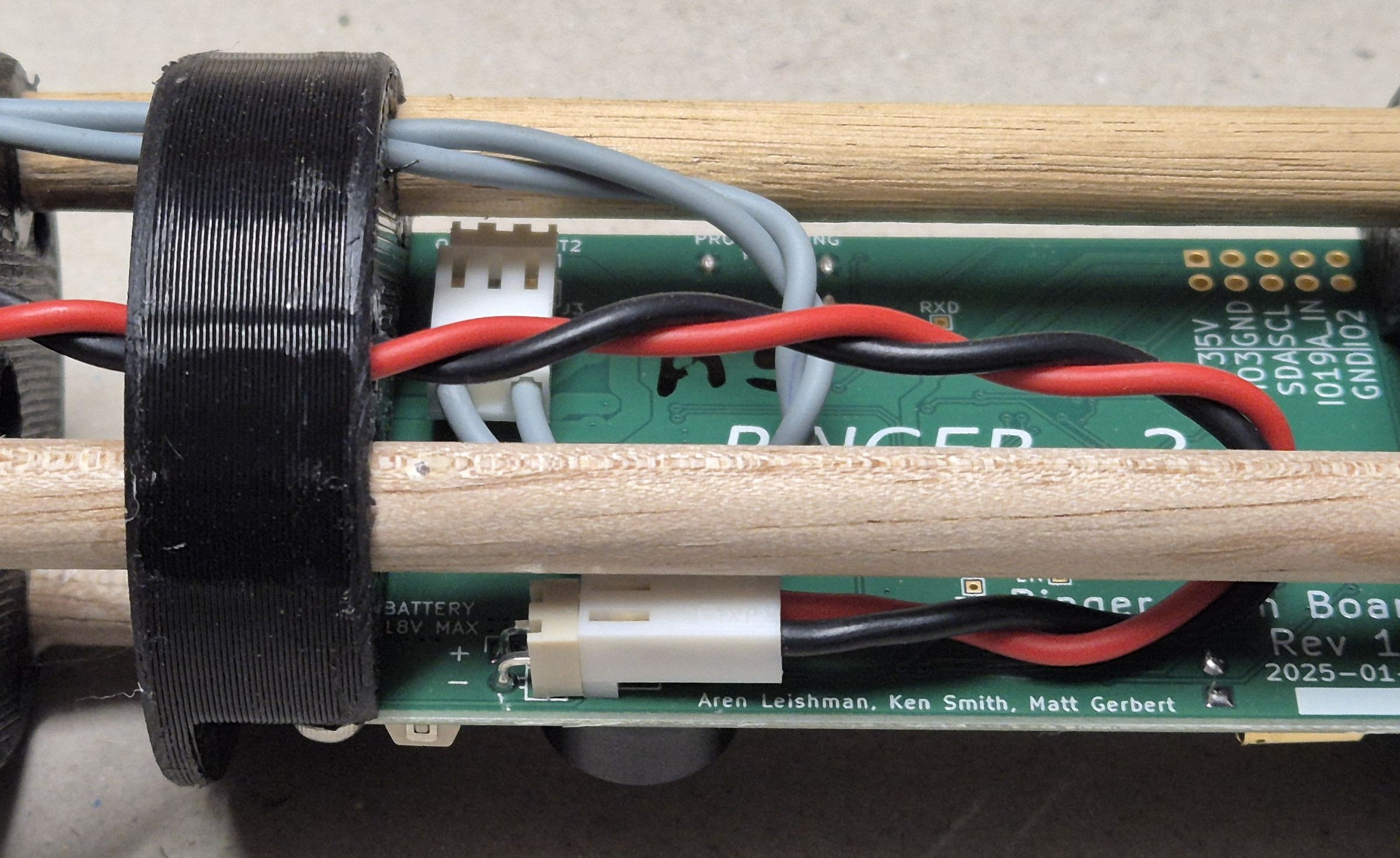 Wiring connections between the transmit coil and control PCB. The board silk-screen shows the project collaborators.